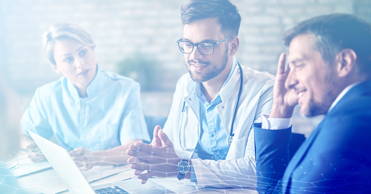 A team of doctors speaks with a patient