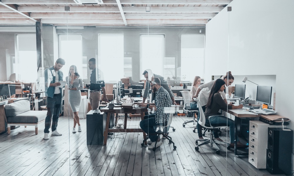 A team works in a modern office space with bright natural light