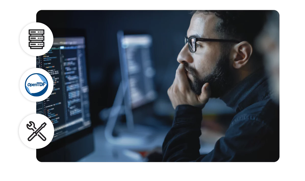 A developer looks at code on a desktop monitor. 