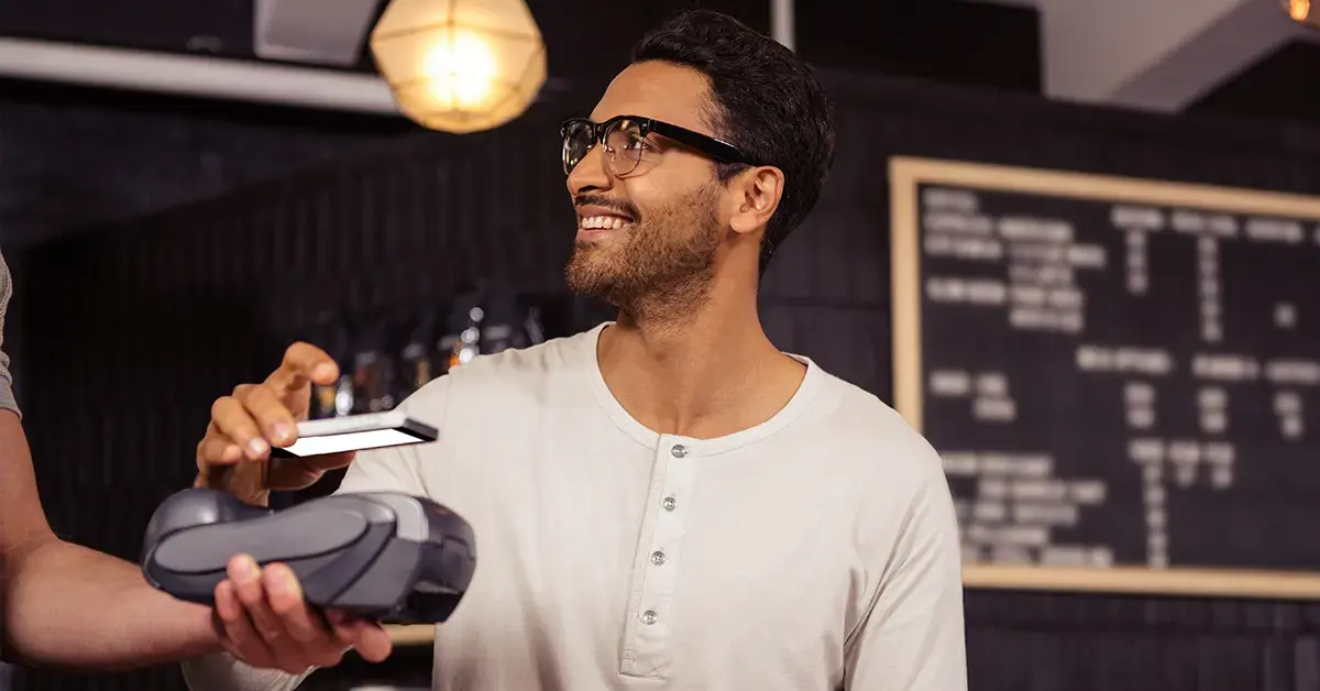 a man pays for a purchase with his phone