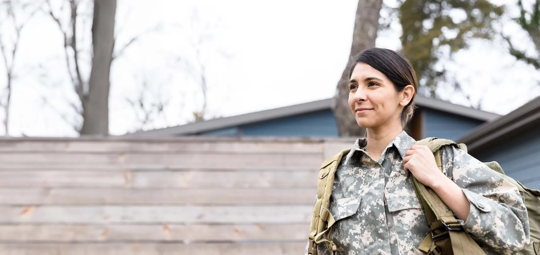 Female soldier walking in a neighborhood