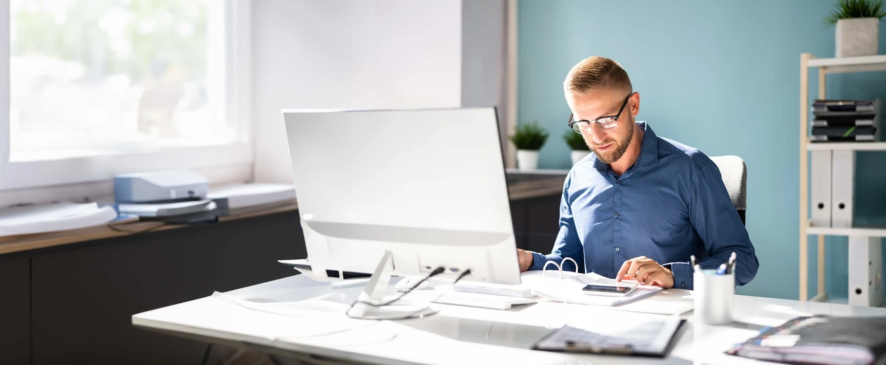 A man works on his computer in an office