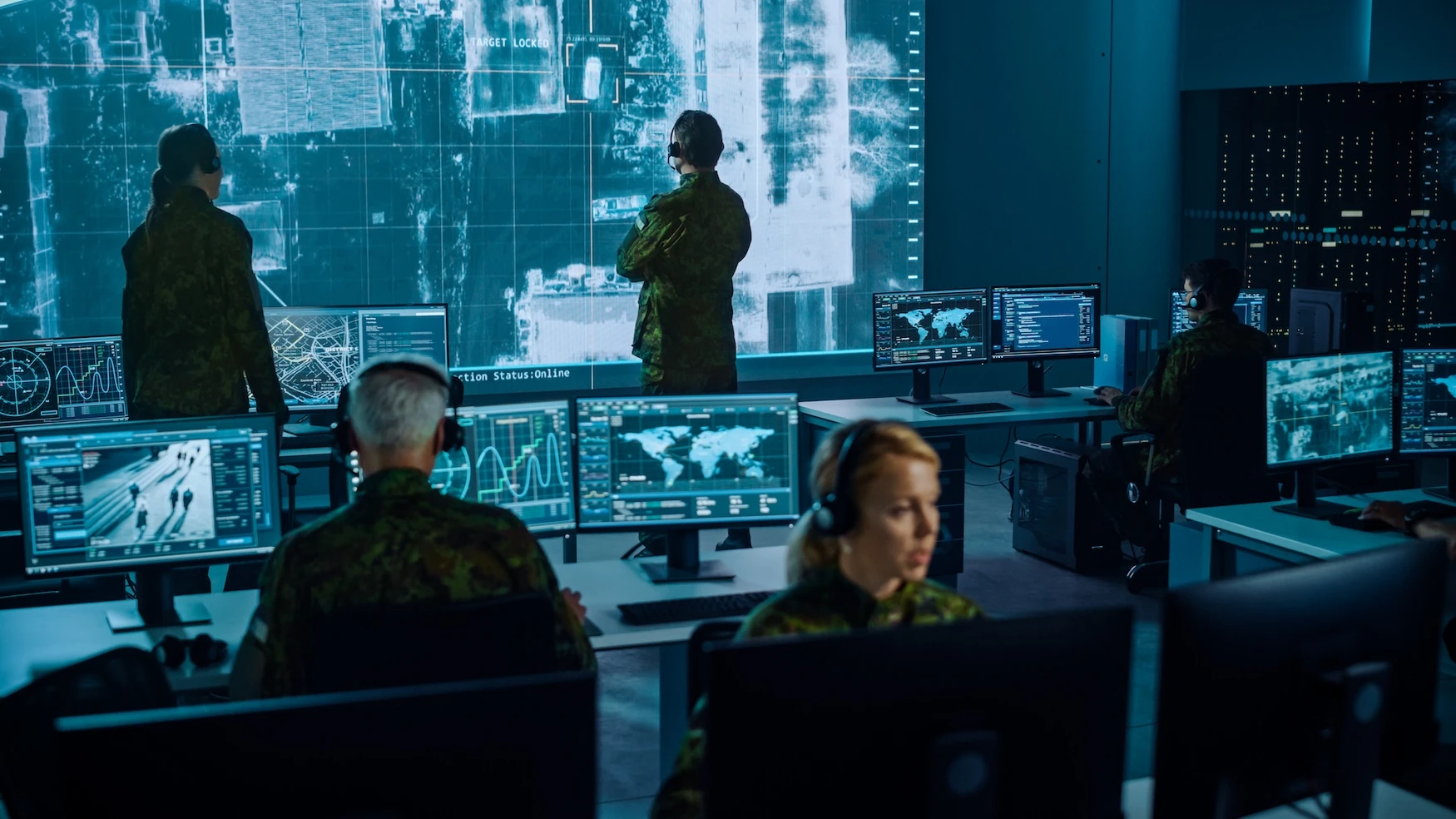 Military Intelligence professionals working in a computer room