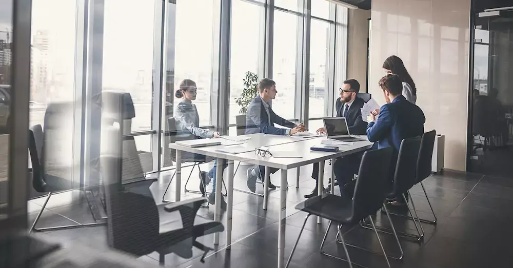 A group of business people in a meeting room. 