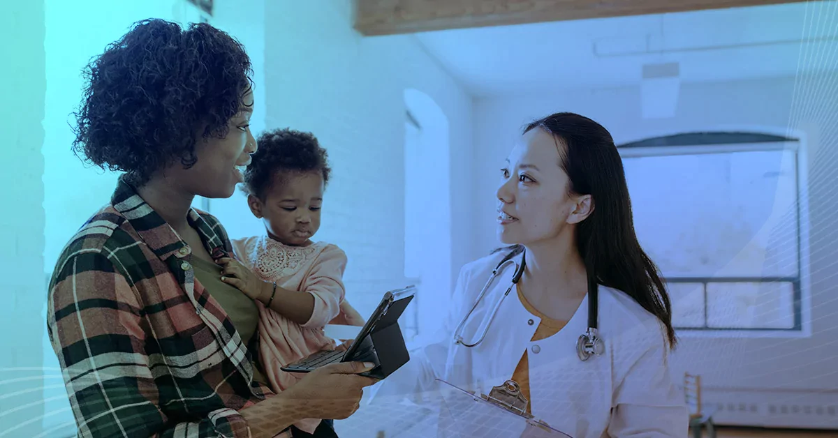 A woman holding here baby and speaking with the child