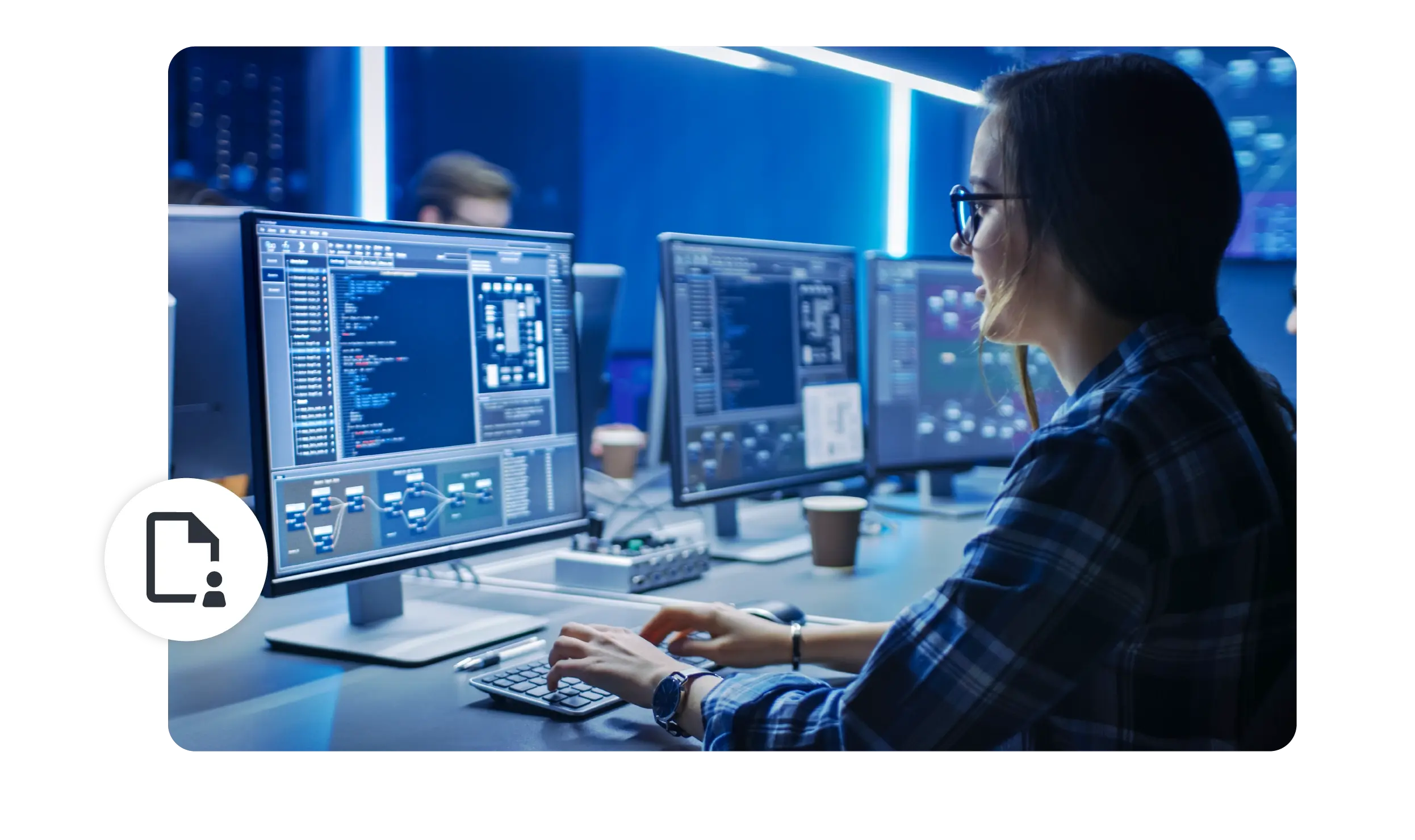 A woman works at a desktop computer tagging information.