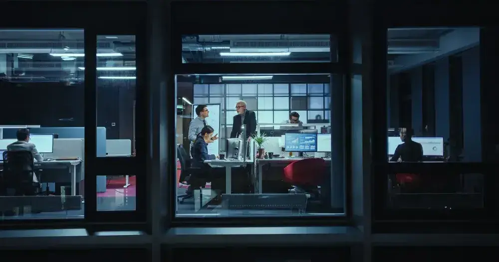 a team works in an office with large windows. 