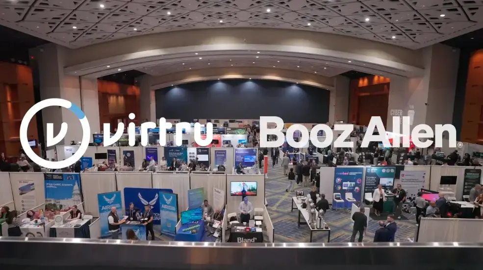 Virtru + Booz Allen logos overlay the Billington Cybersecurity Conference Floor